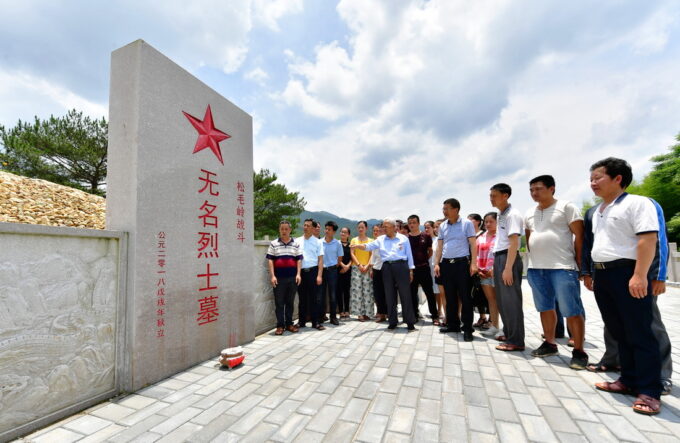 2019年6月16日，在福建省长汀县南山镇长窠头村，钟宜龙老人在松毛岭战斗无名烈士墓前介绍松毛岭战斗的历史。新华社记者魏培全摄